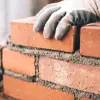 man laying brick